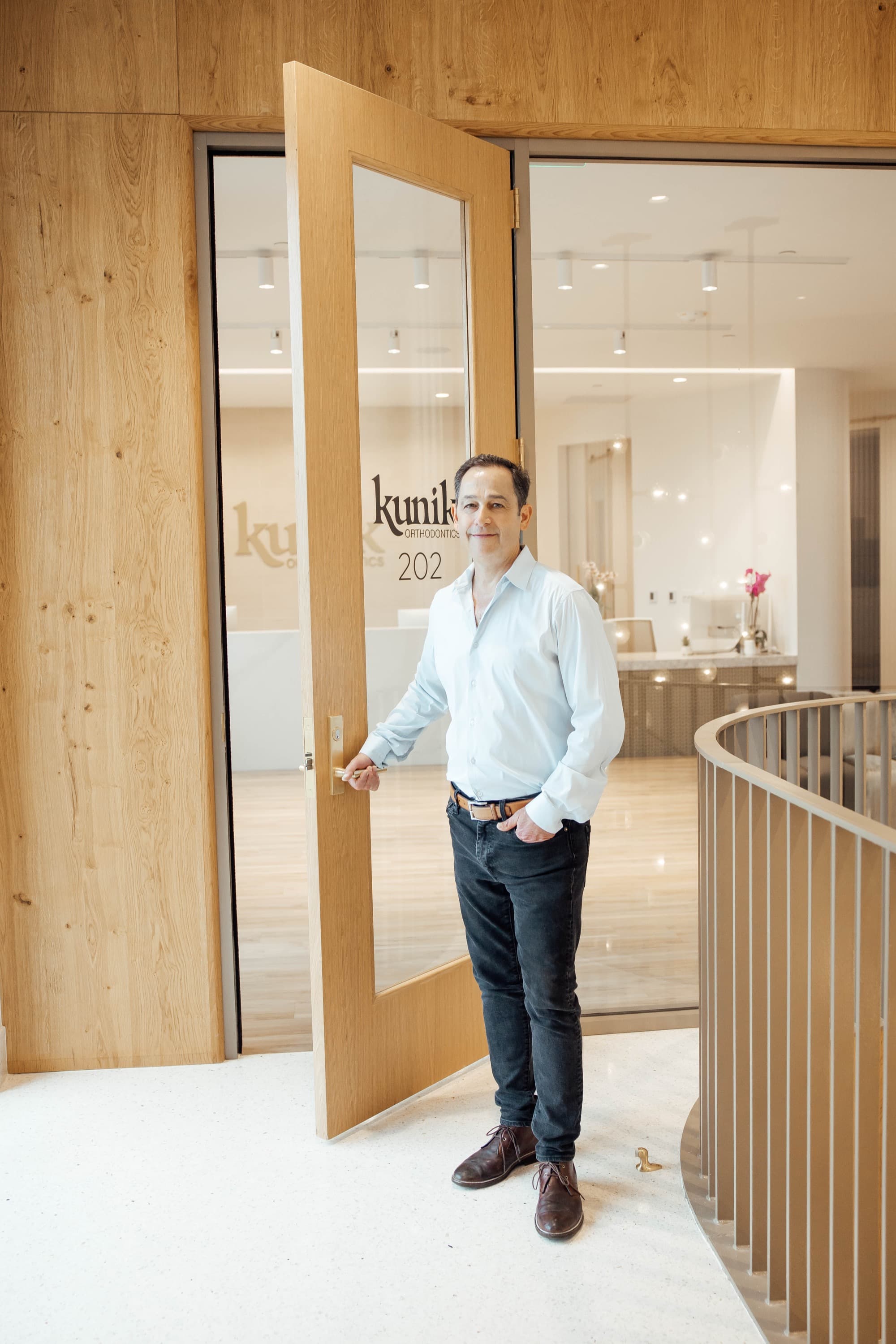 Dr. Kunik welcoming patients at office entrance