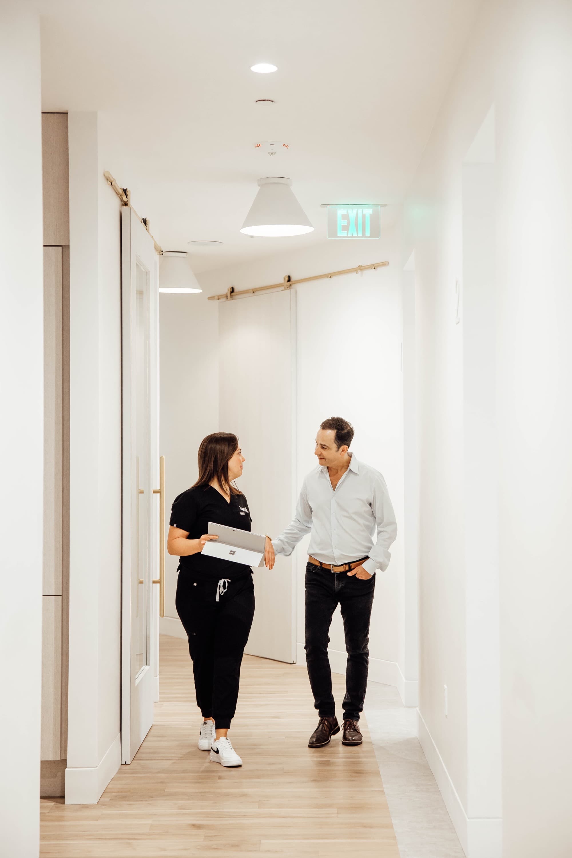 Dr. Kunik walking through the office with team member