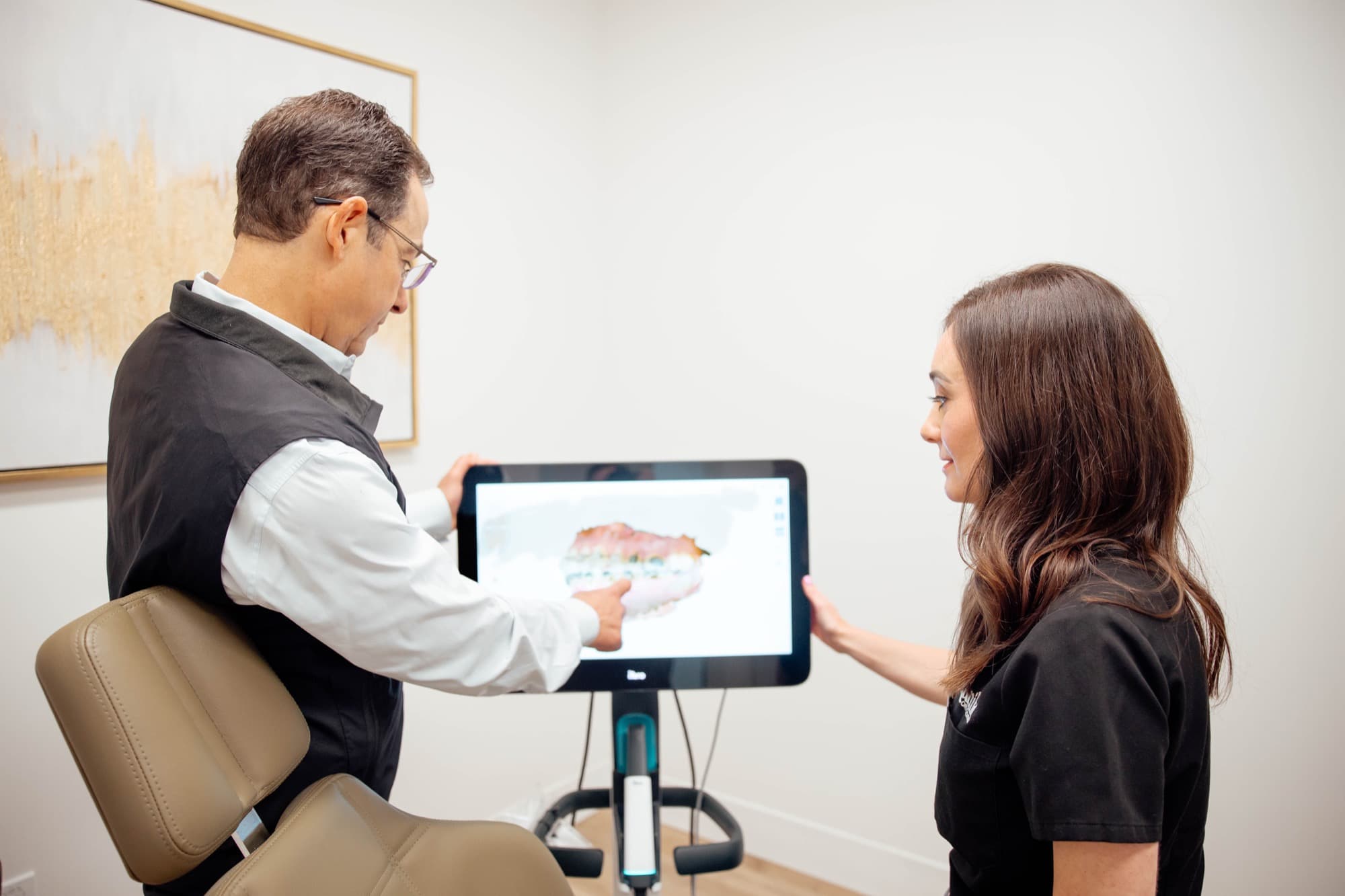 Dr. Kunik reviewing digital scan with patient
