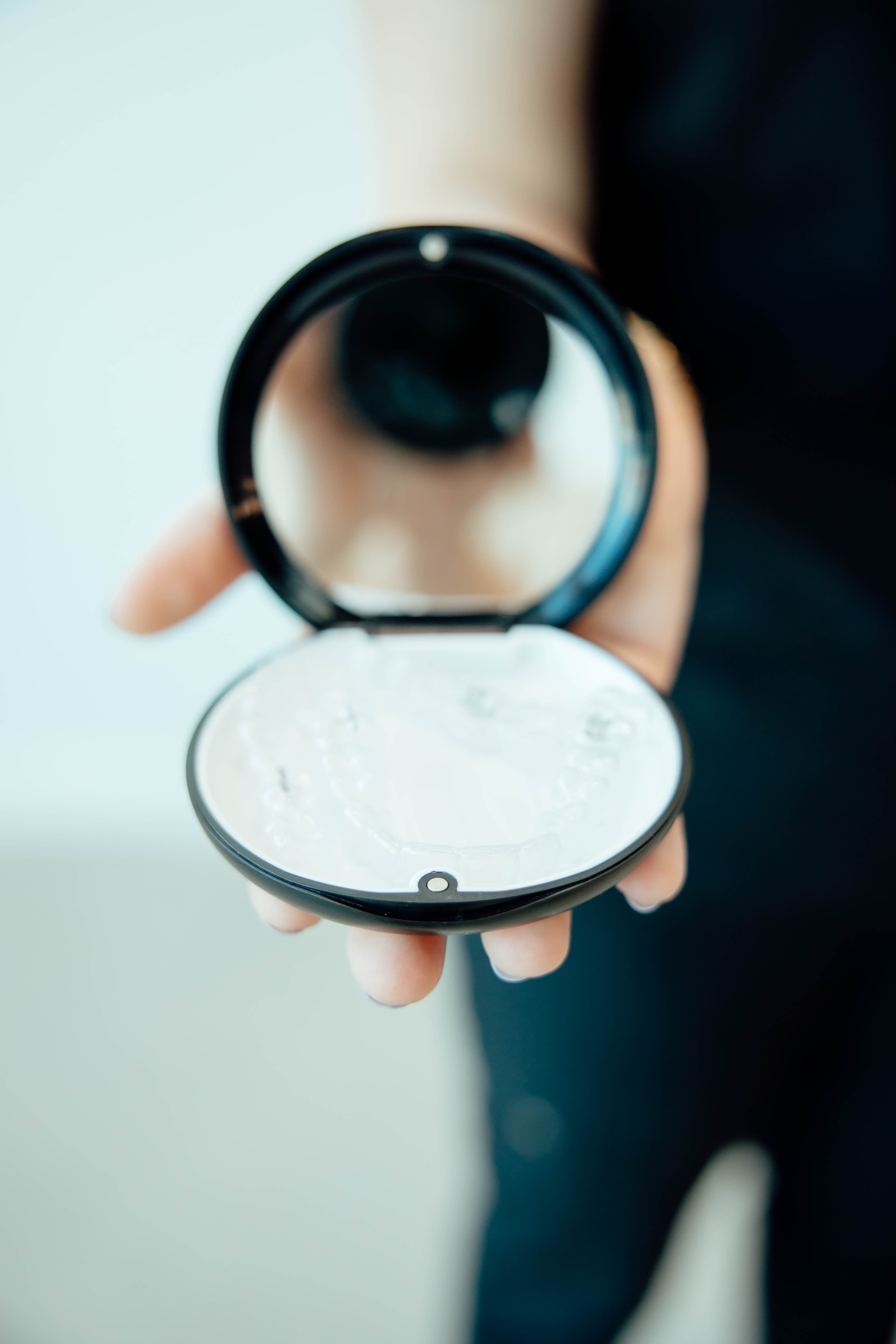 Person holding Invisalign aligner